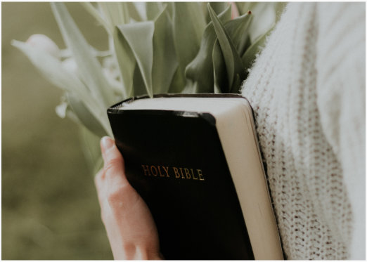 A woman holding Bible